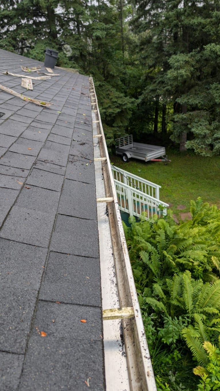 Gutter cleaning mid-service on a Georgian Bay home